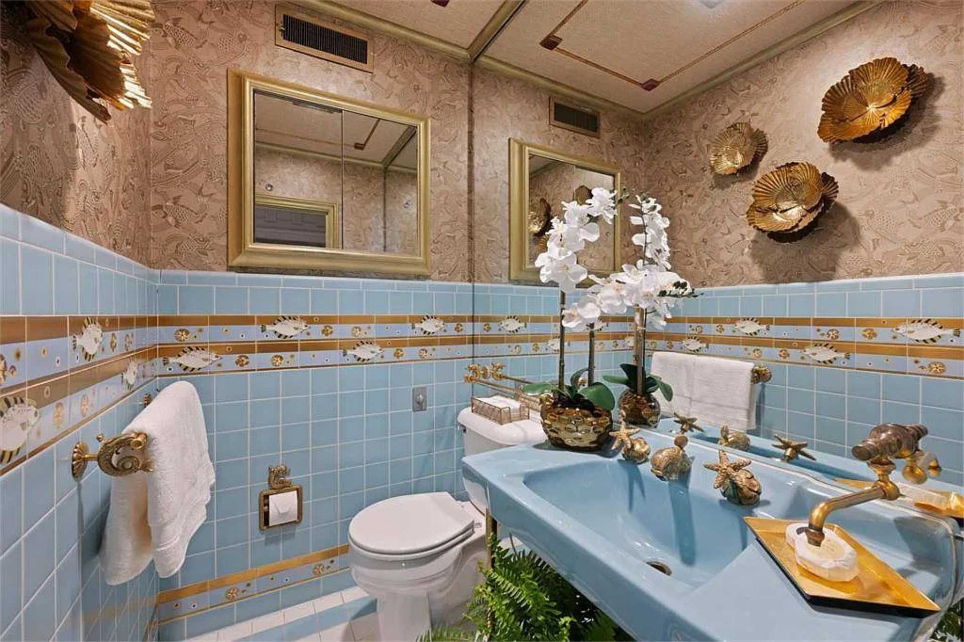 Original tiled bath with hand-painted fish border and gilded fixtures