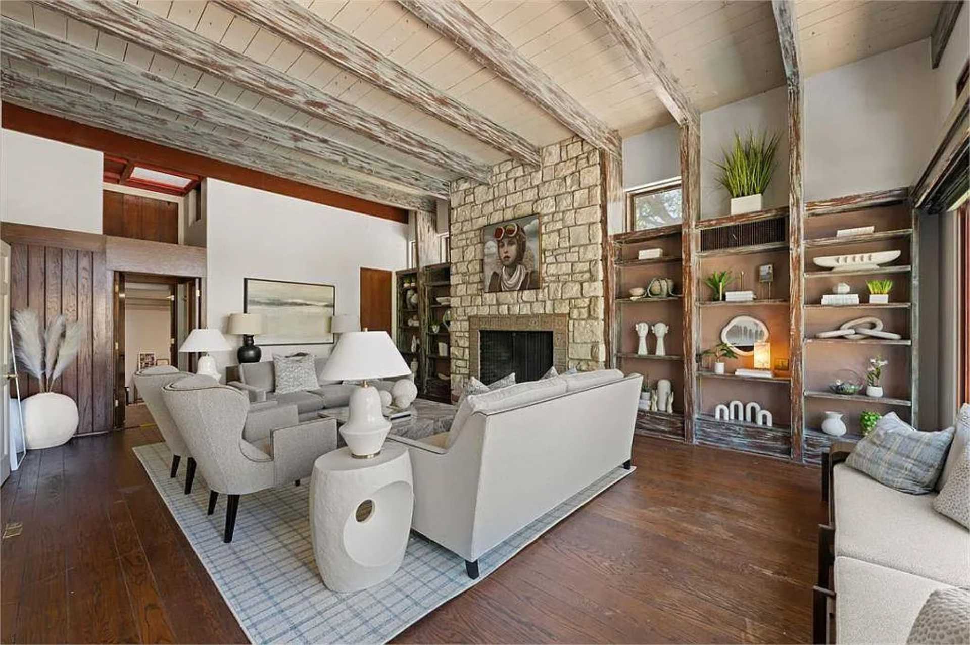 Living room with whitewashed beams and built-in shelving