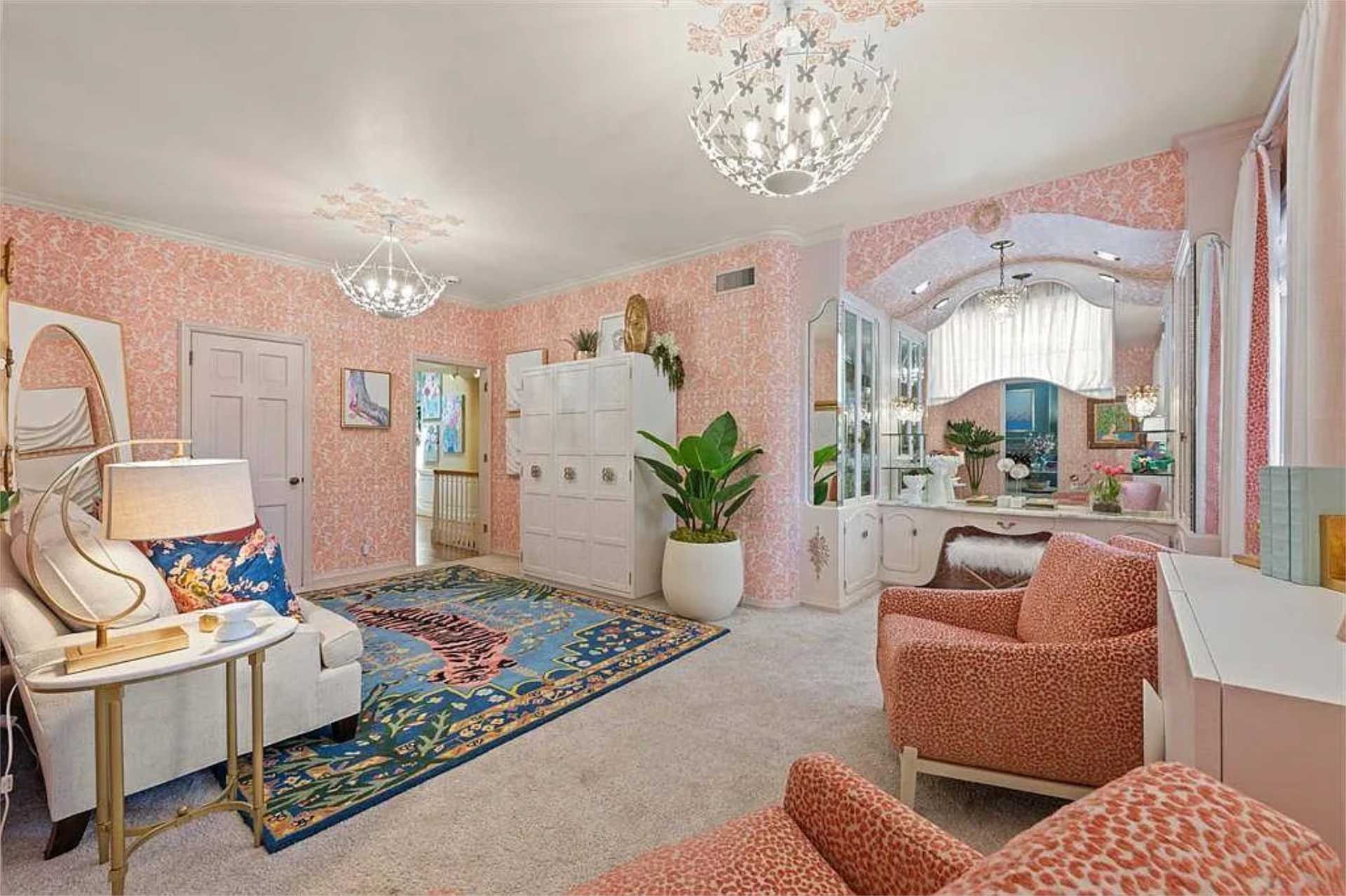 Pink-wallpapered sitting room with chandeliers