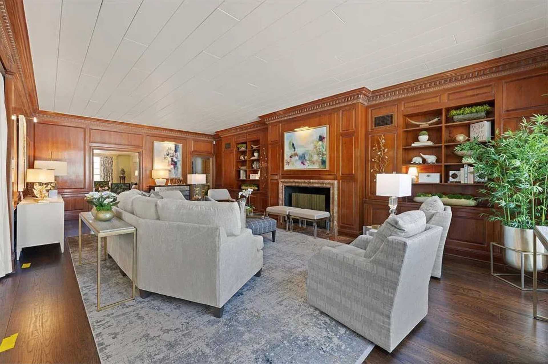 Library with built-in bookcases and limestone mantel