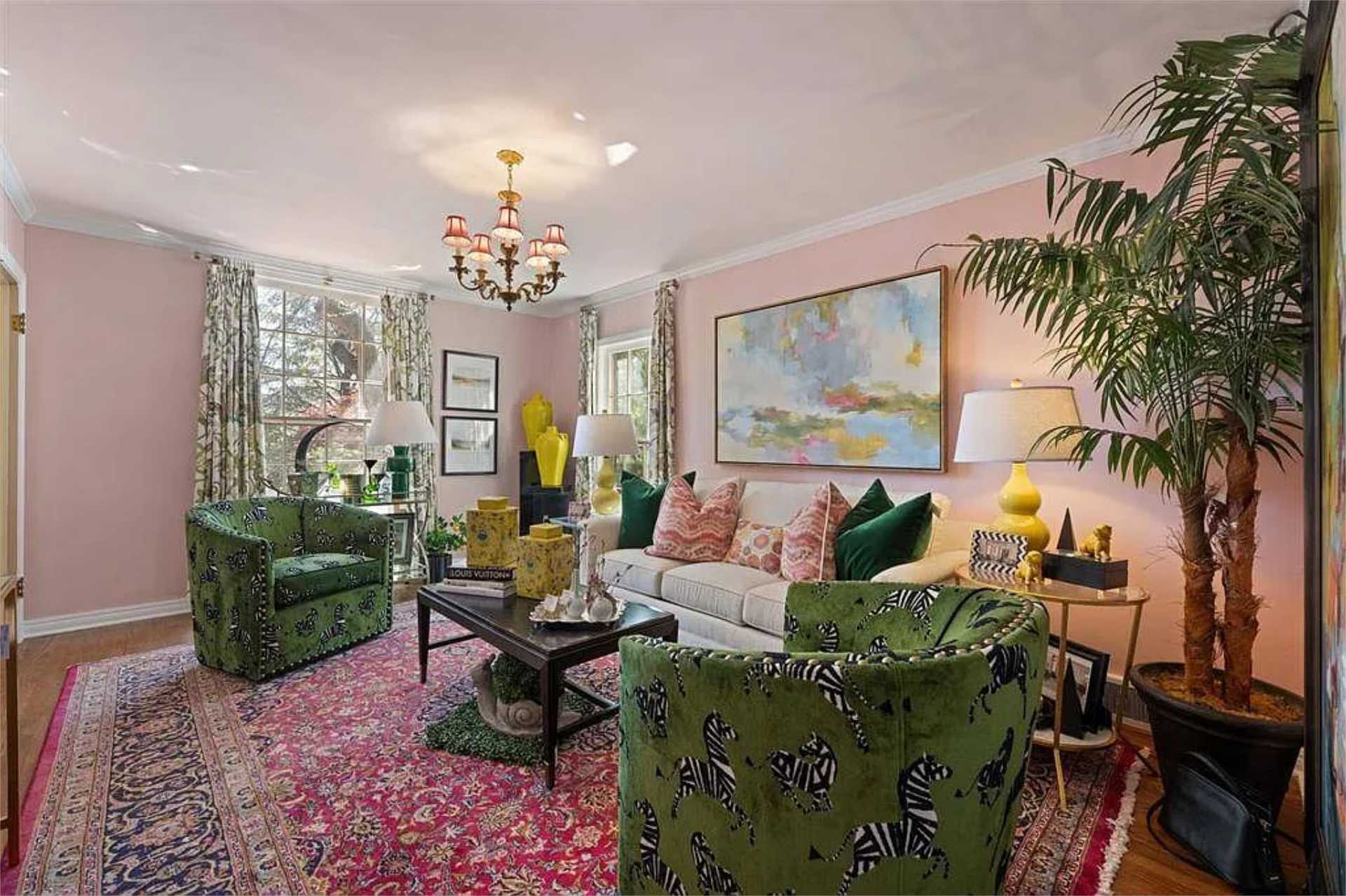 Pink salon with chandelier and bold patterned seating