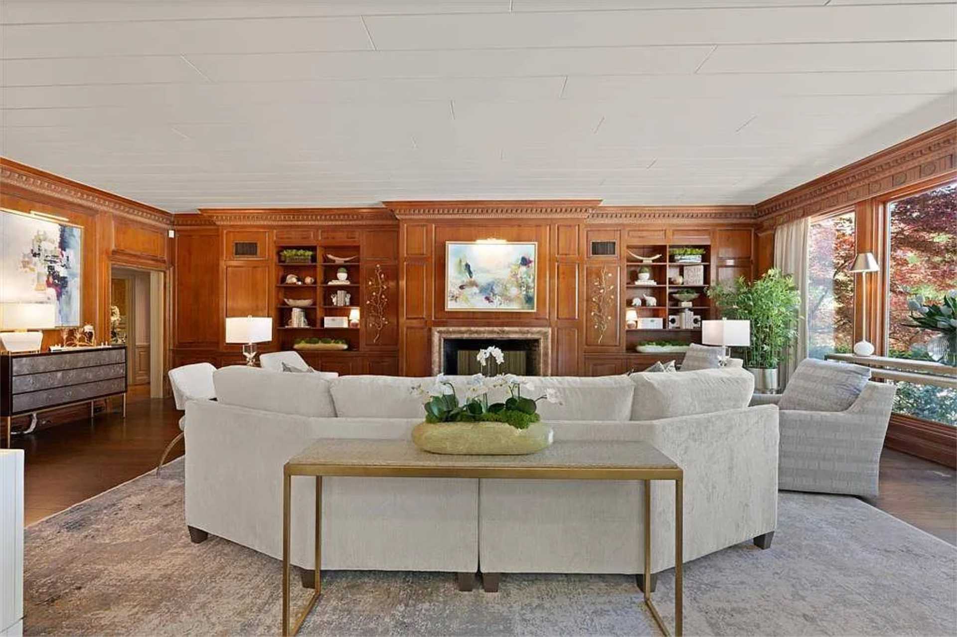 Walnut-paneled great room with carved fireplace