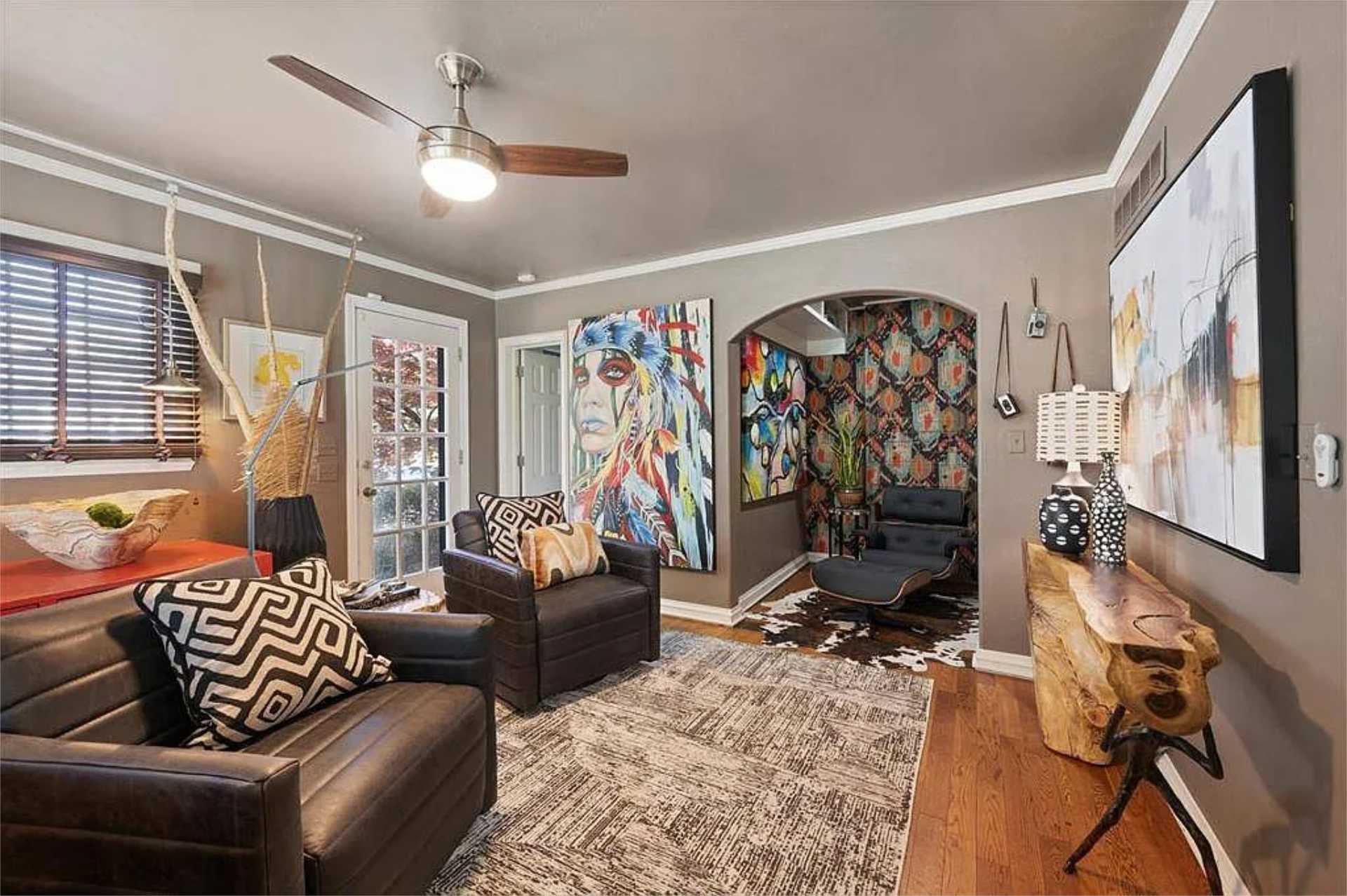 Eclectic lounge with bold artwork and cowhide rug