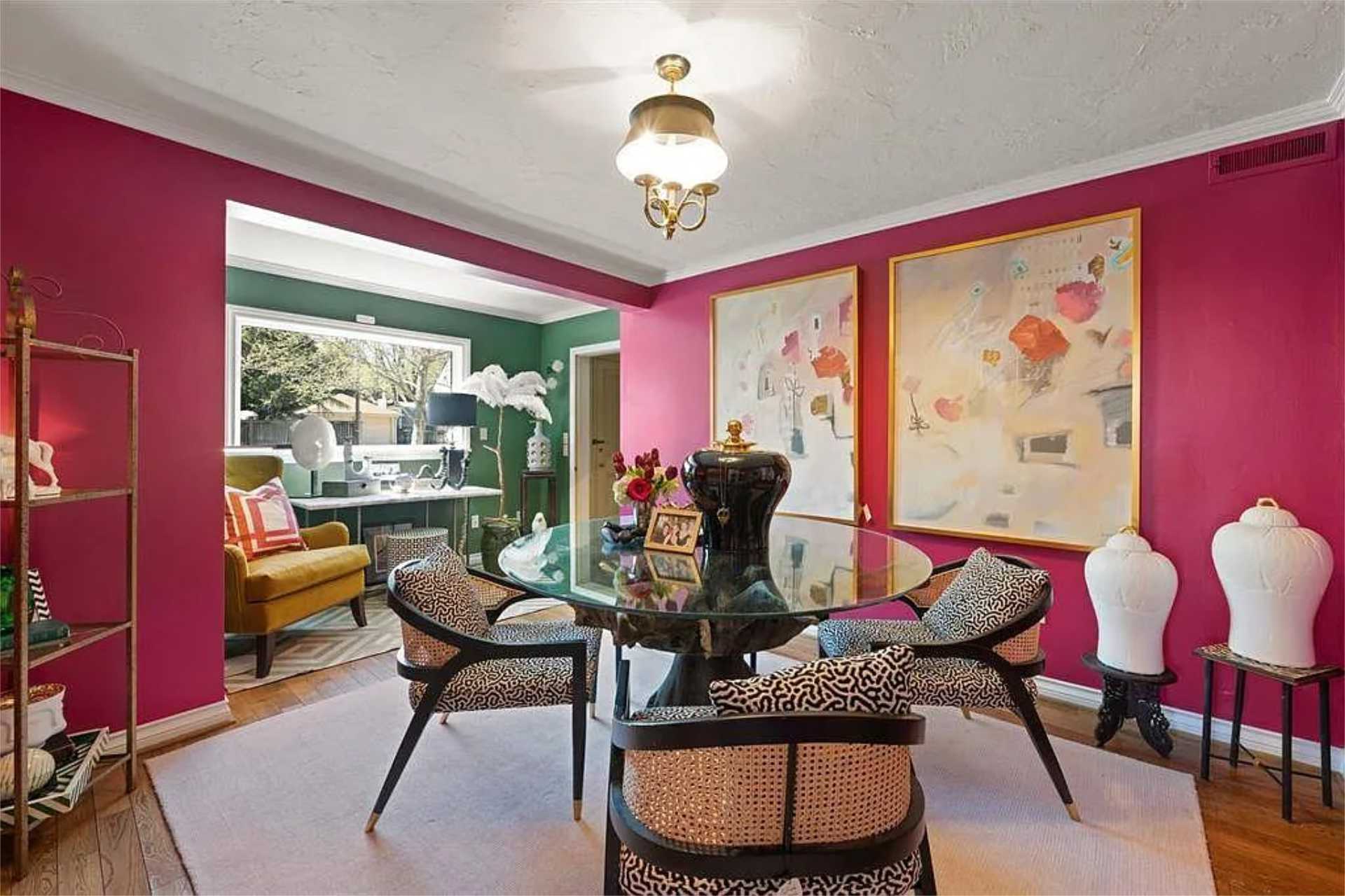 Magenta dining room with cane and leopard print chairs