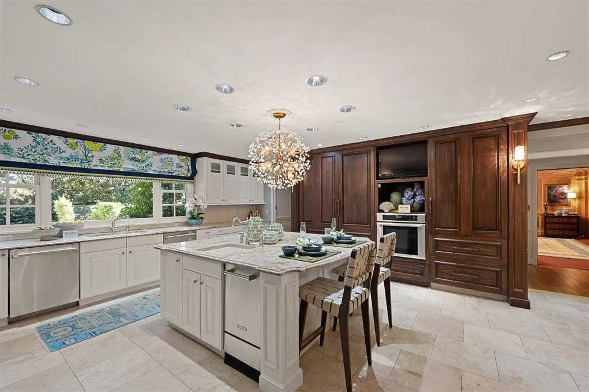 Kitchen island with prep sink and walnut built-ins