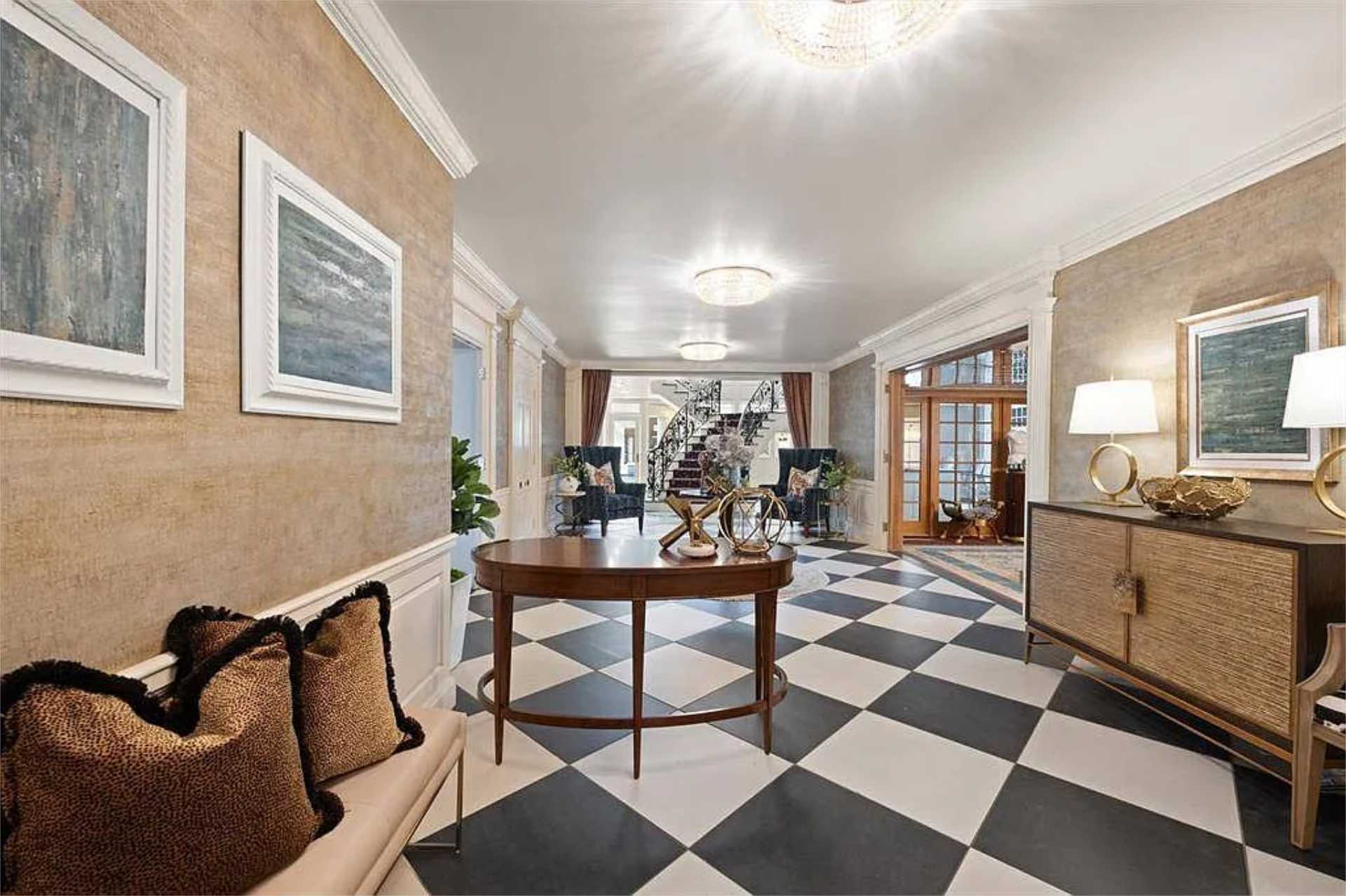 Grand foyer with checkered marble floors and crystal chandelier