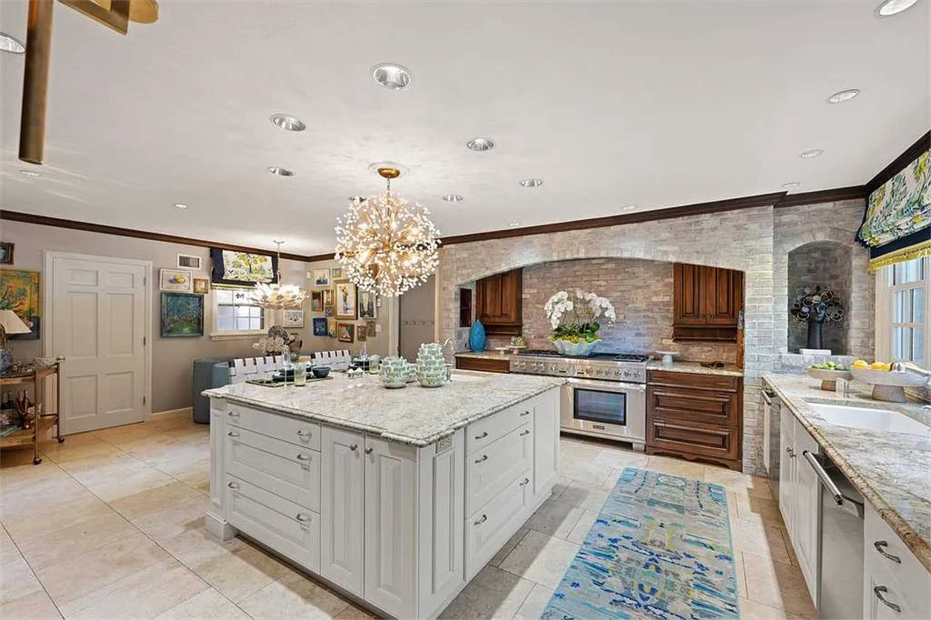 Chef's kitchen with stone-arch range and crystal chandelier