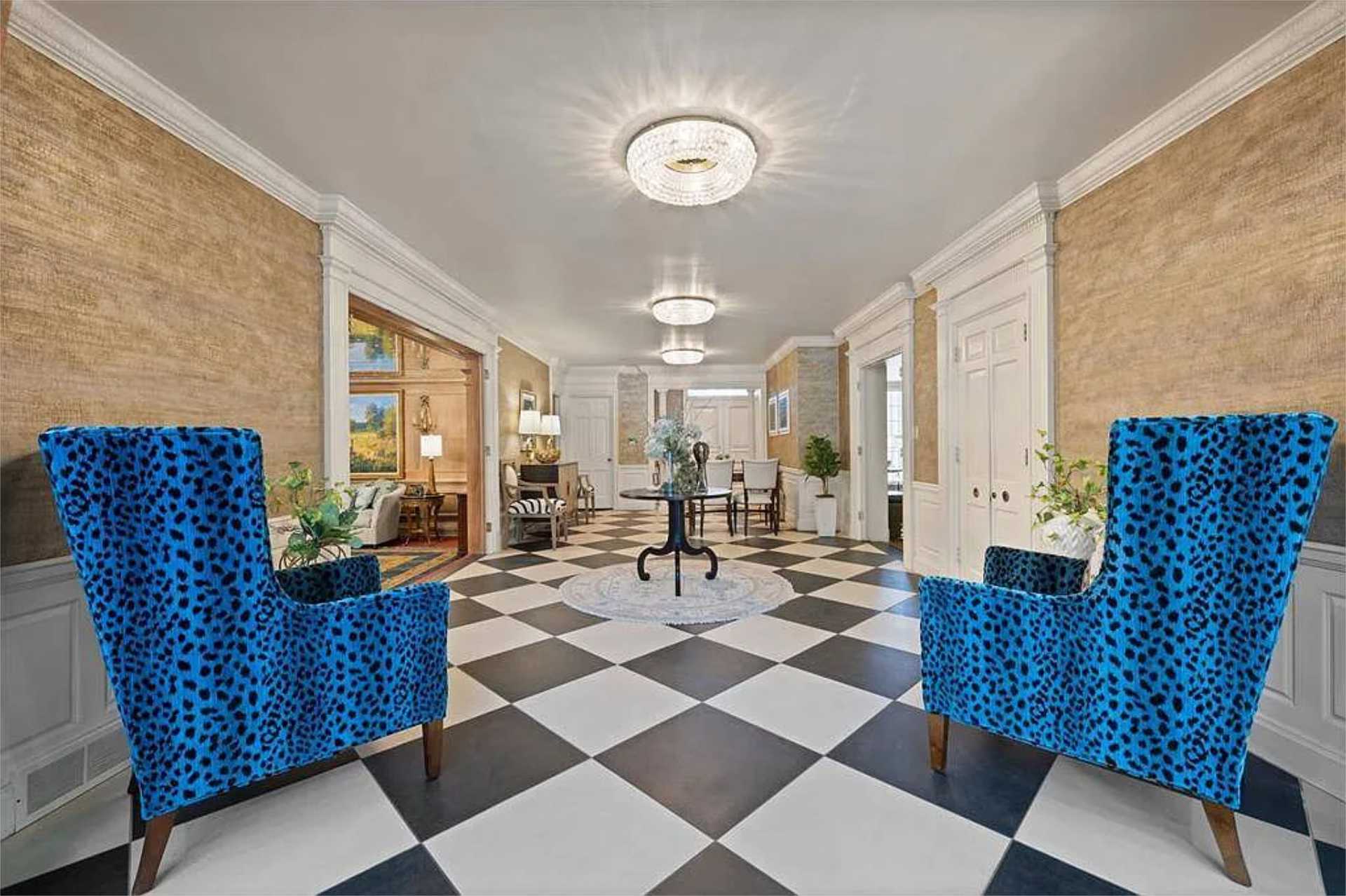 Entry hall with sculptural blue wingback chairs