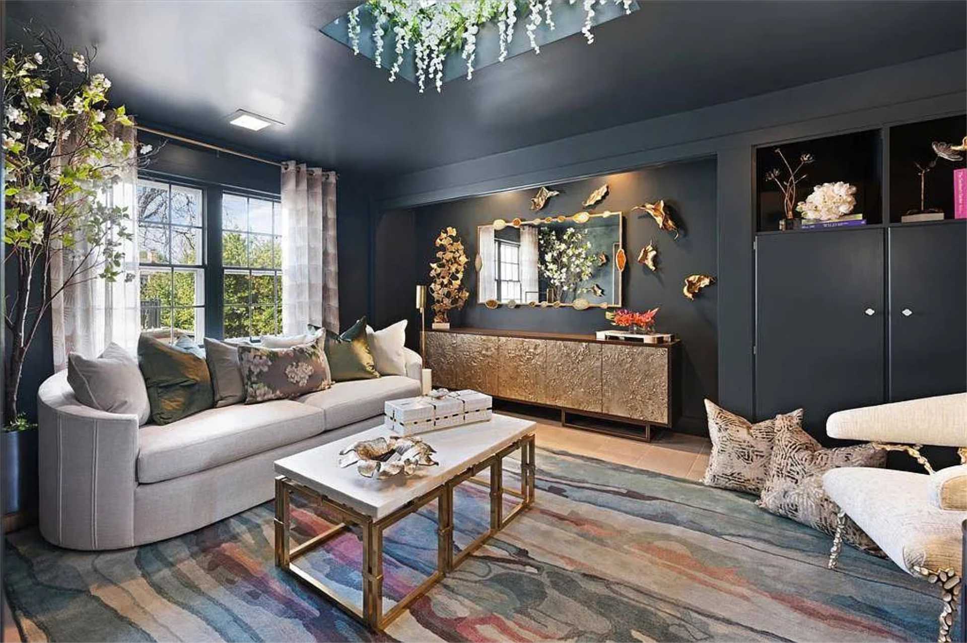 Moody navy sitting room with gilded credenza